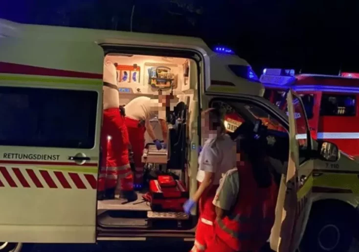 Symbolfoto von 5min.at: Sanitäter bei einem Rettungswagen bei Nacht