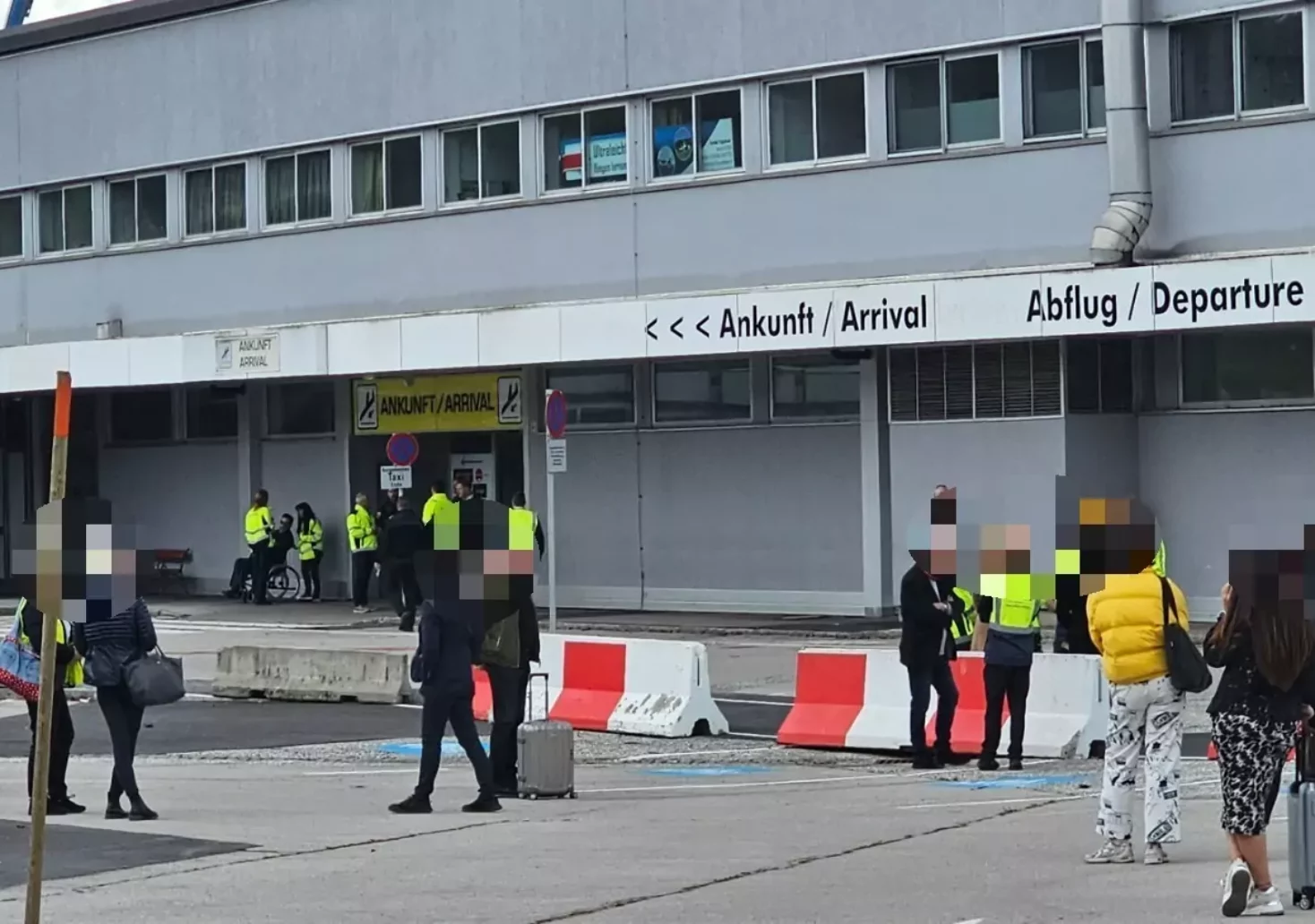 Foto in Beitrag von 5min.at: Zu sehen ist das Flughafengebäude in Klagenfurt von außen, viele Menschen stehen davor.