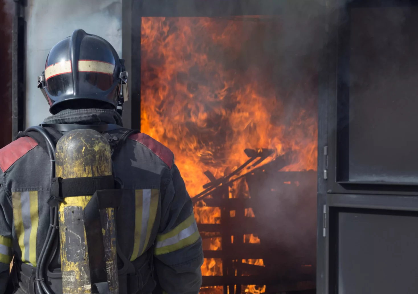 Ein Foto auf www.5min.at zeigt einen Feuerwehrmann, der ein Feuer löscht.