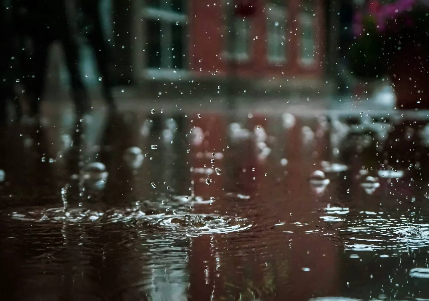 Das Bild auf 5min.at zeigt Regentropfen auf Asphalt.