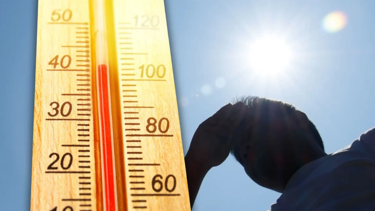 Foto in Beitrag von 5min.at zeigt ein Thermometer, einen Mann und die Sonne.